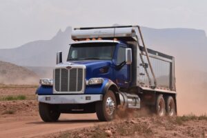 Dump-Truck-Loans-Dump-Truck-Financing-Blue-dump-truck-on-dirt-road