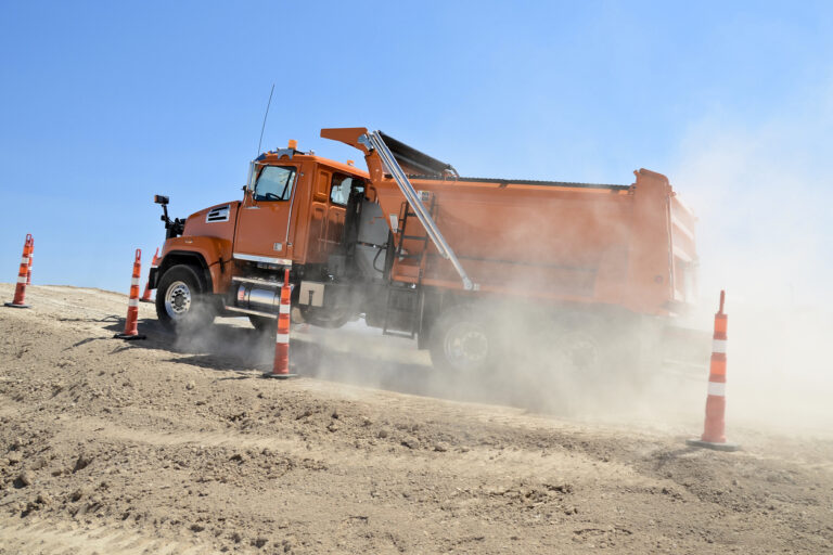 U.S. Dump Truck Directory-Orange dump truck at job site