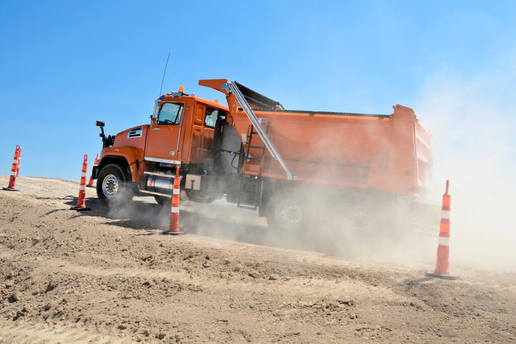 Dump Truck Dealership Directory - Orange dump truck going uphill