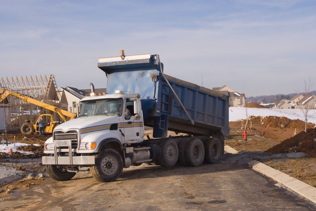 Subcontracting dump truck work - How Subcontracting Can Grow Your Dump Truck Business - Dump truck at construction site