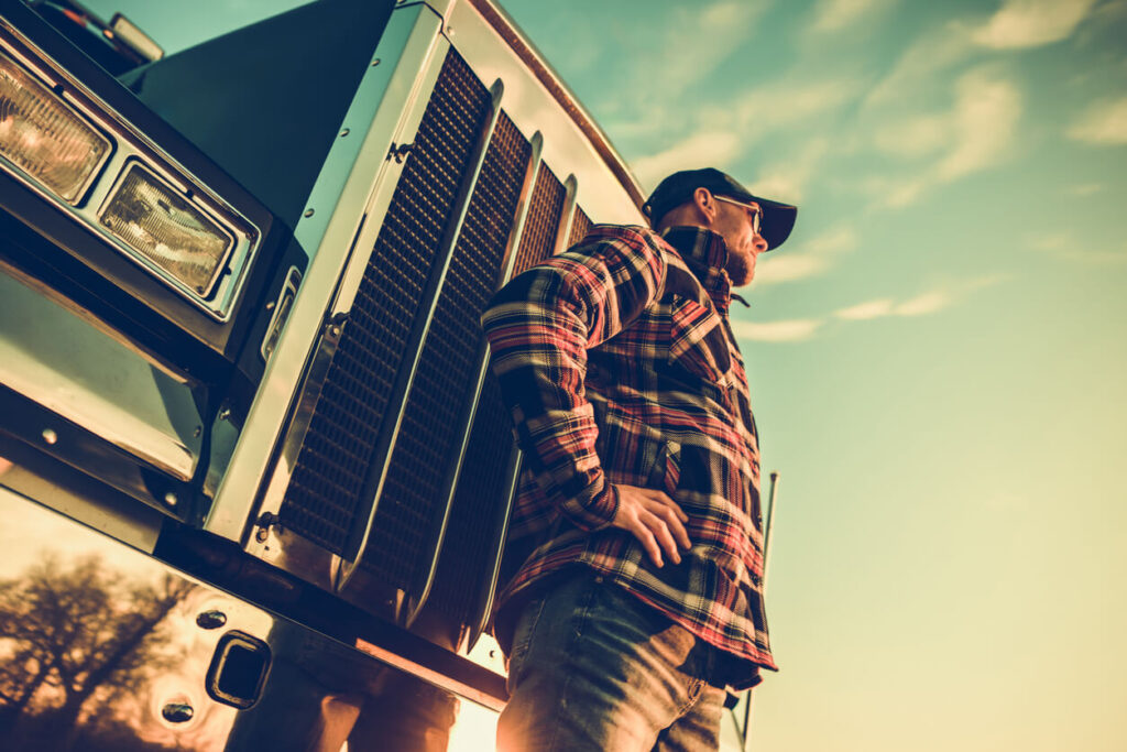 Subcontracting for business growth - A Power Move - Dump Truck Driver standing in front of dump truck