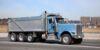 Blue Dump Truck on the Highway - Understanding Dump Truck Terminology: A Beginner’s Guide