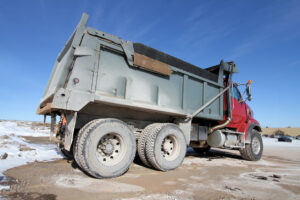 Red dump truck on snowy ground