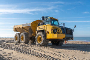 reliable dump truck driver yellow beach dump truck