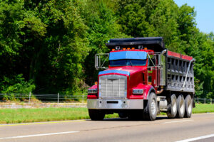 Red dump truck on highway 10 profitable dump truck jobs red
