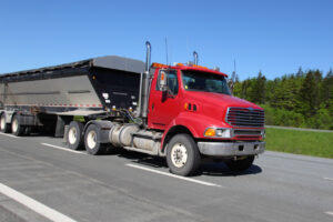 Red truck on highway with trailer Good Credit