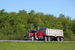 Red dump truck jobs on a highway