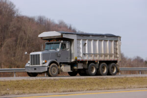 Buying your first dump truck Gray dump truck on highway