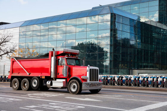 How to sell a dump truck, red Infront of bikes