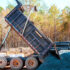 Dump truck unloading gravel on site